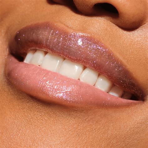 Detail ženského líčenia očí s jemnými trblietkami a pery s decentným leskom.