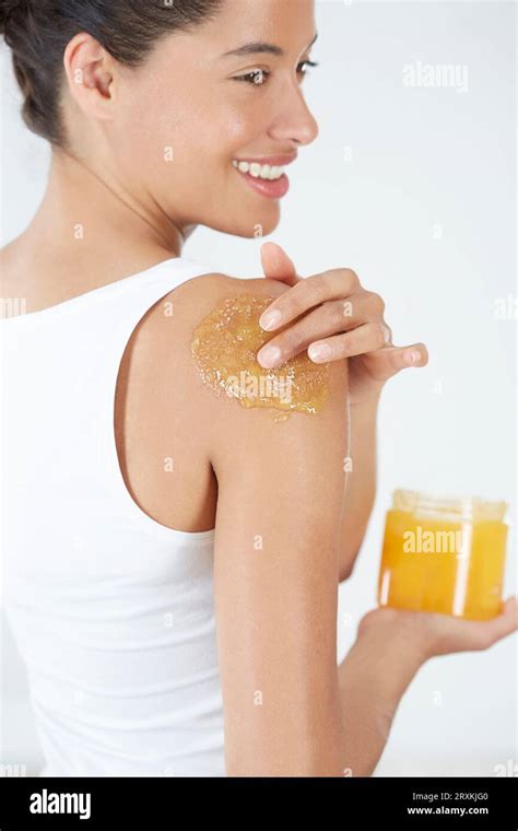 Photo of a woman applying a pumpkin hair mask or body scrub